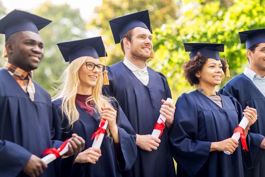 happy-students-in-mortar-boards-with-diplomas-2023-11-27-05-13-12-utc